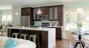 Modern kitchen with brown cabinets and white waterfall countertop