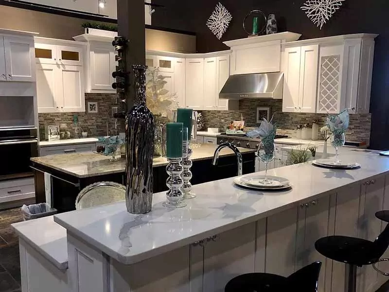 Large kitchen in showroom with white cabinets