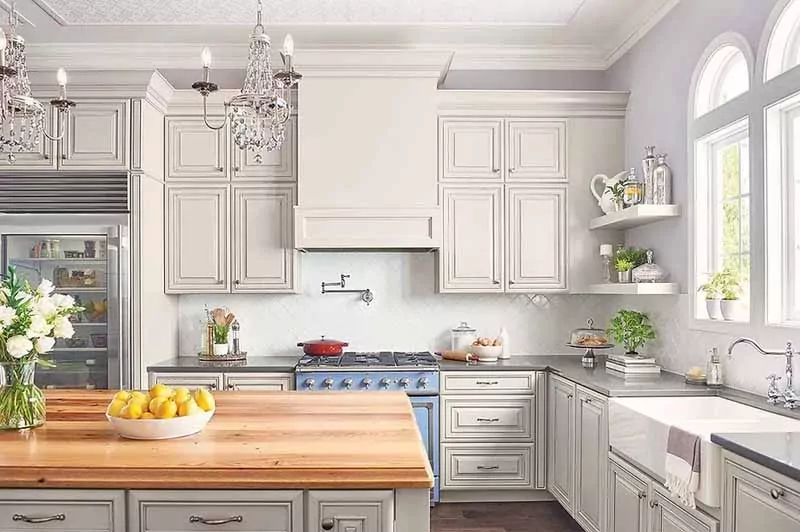 Luxurious kitchen with decorative white cabinets and wooden countertop