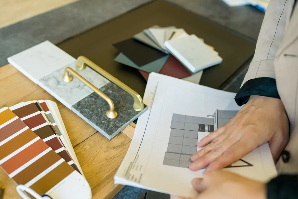 person looking through kitchen design materials