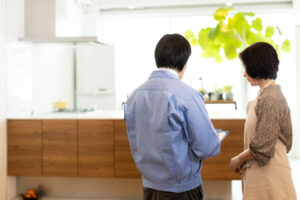 two people standing in kitchen